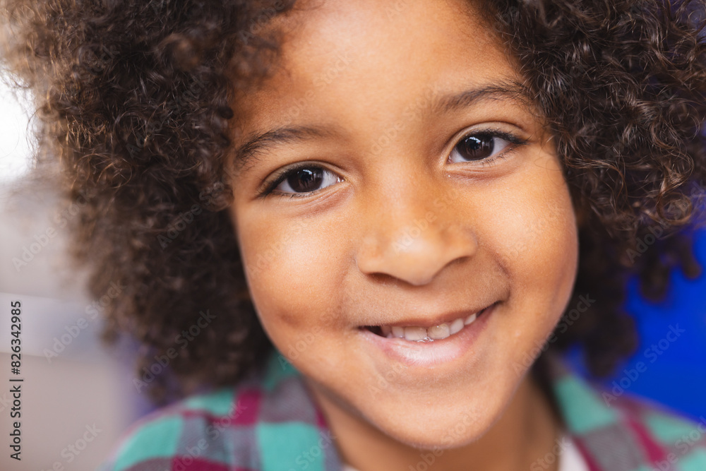 In school, young biracial boy is smiling at camera In school, young biracial boy is smiling at camera