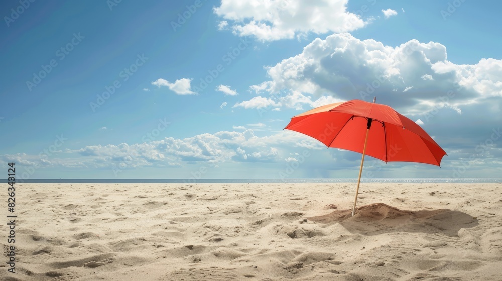Bright red umbrella on empty sandy beach under clear blue sky with clouds Bright red umbrella on empty sandy beach under clear blue sky with clouds
