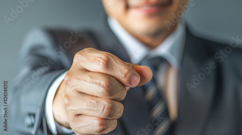 Businessman in suit pulls his fist forward. Friendship concept at work
