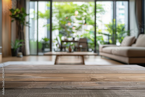 A wooden coffee table in the foreground with a blurred background of a minimalist living room. The background features sleek furniture  clean lines and large windows.