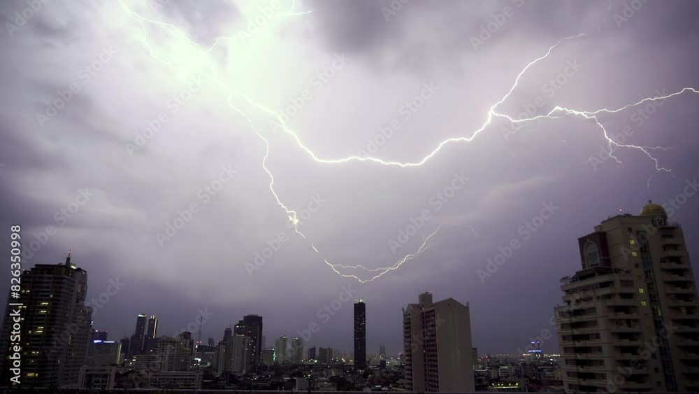 Lightning over the city. Real flashes of lightning over the city during a powerful thunderstorm. Lightning strikes on a dark night sky. 