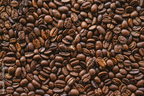 Close up of dark roasted coffee beans filling the frame can be use as background. 
