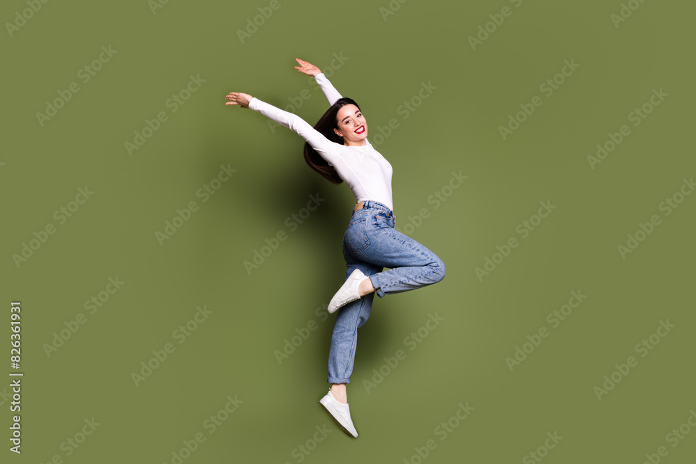 Full size photo of pretty young girl dance raise hands elegant wear trendy white outfit isolated on khaki color background Full size photo of pretty young girl dance raise hands elegant wear trendy white outfit isolated on khaki color background