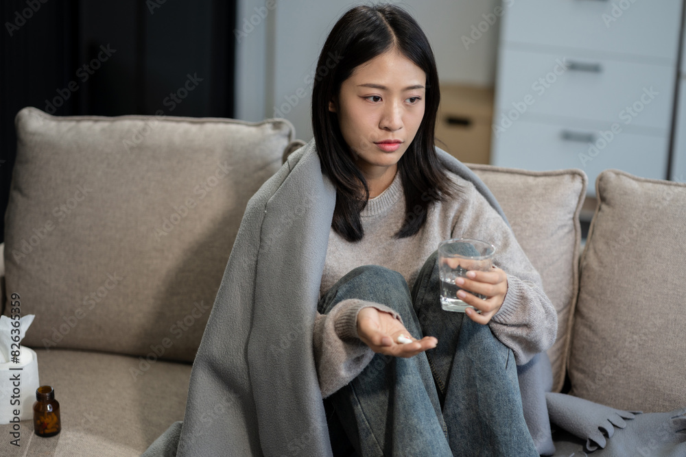 Young woman holding medicine and glass of water, feeling sick, health care concept. Young woman holding medicine and glass of water, feeling sick, health care concept.