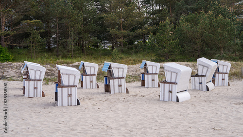 Fototapeta Naklejka Na Ścianę i Meble -  Very beautiful view of the sandy beach of the Baltic Sea. There are traditional German sun loungers with a hood on the white sand. (Strandkorb). Germany, Usedom