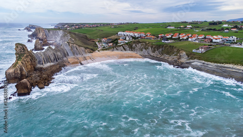 Portio Beach aerial view, sharp cliffs, rock formations, ocean. Cantabria, Spain. photo