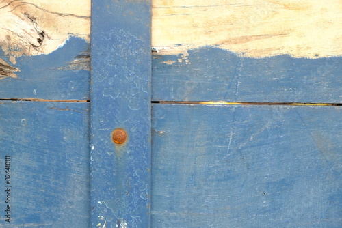 stacked blue yellow wooden planks, nailed. sengon wood. This image is suitable for use as a background or wallpaper.. old wooden door. 