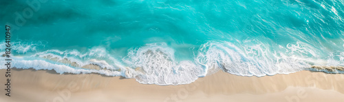 A beautiful turquoise ocean with soft waves on a sandy beach. Perfect for summer vacation or travel banner backgrounds.