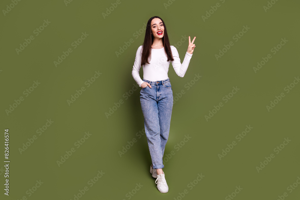 Full size photo of pretty young girl point empty space wear trendy white outfit isolated on khaki color background Full size photo of pretty young girl point empty space wear trendy white outfit isolated on khaki color background