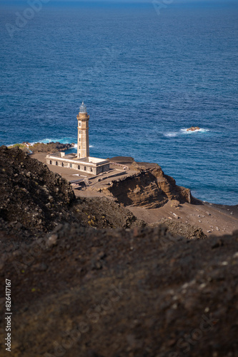 Farol da Ponta dos Capelinhos lighthouse at Faial island of the Azores, Portugal. Former beacon on the Atlantic Ocean coast. Eruption of Capelinhos volcano.