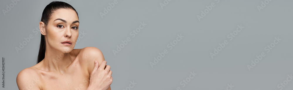 Appealing woman with very long hair stands on white backdrop. Appealing woman with very long hair stands on white backdrop.