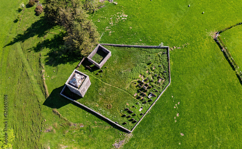 Aerial view of Tower of Repentance in high grass meadow, Lockerbie, Scotland, United Kingdom. photo