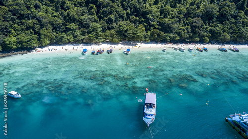 Aerial view of clear turquoise waters with anchored boats at Monkey Beach, Phi Phi Island, Krabi, Thailand. photo