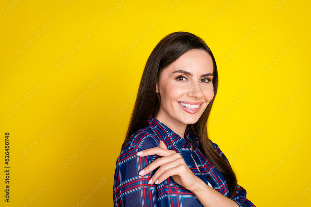 Photo portrait of attractive young woman hugging self dressed stylish plaid clothes isolated on yellow color background Photo portrait of attractive young woman hugging self dressed stylish plaid clothes isolated on yellow color background