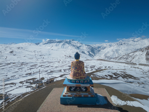 Aerial view of snow capped mountains with Langza Buddha Statue, Kaza, Himachal Pradesh, India.