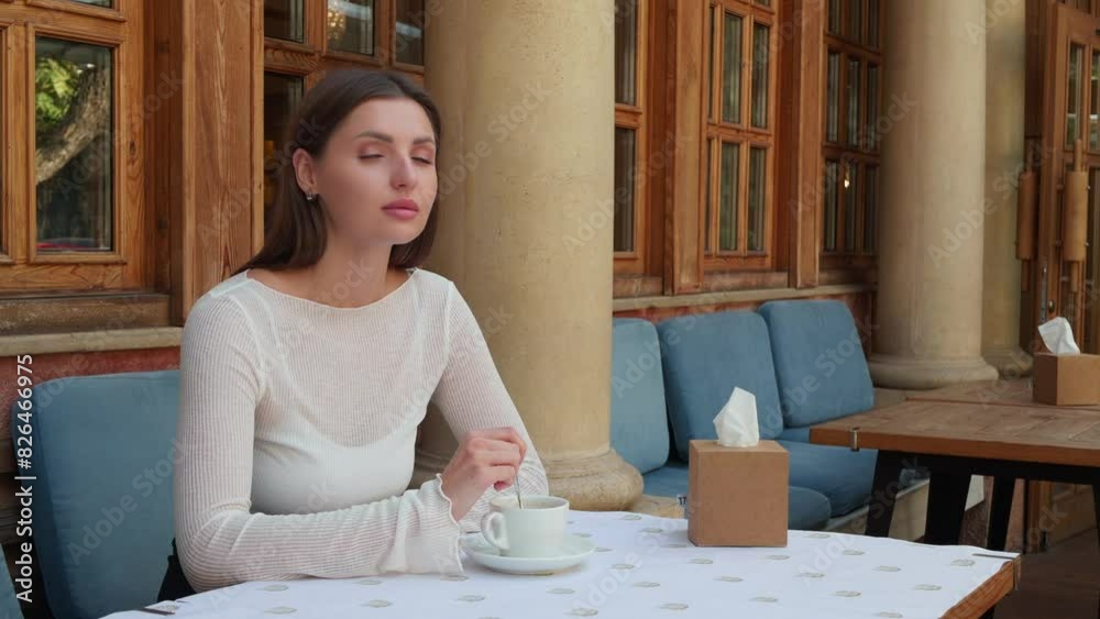 Beautiful woman drinking coffee in outdoor cafe Beautiful woman drinking coffee in outdoor cafe