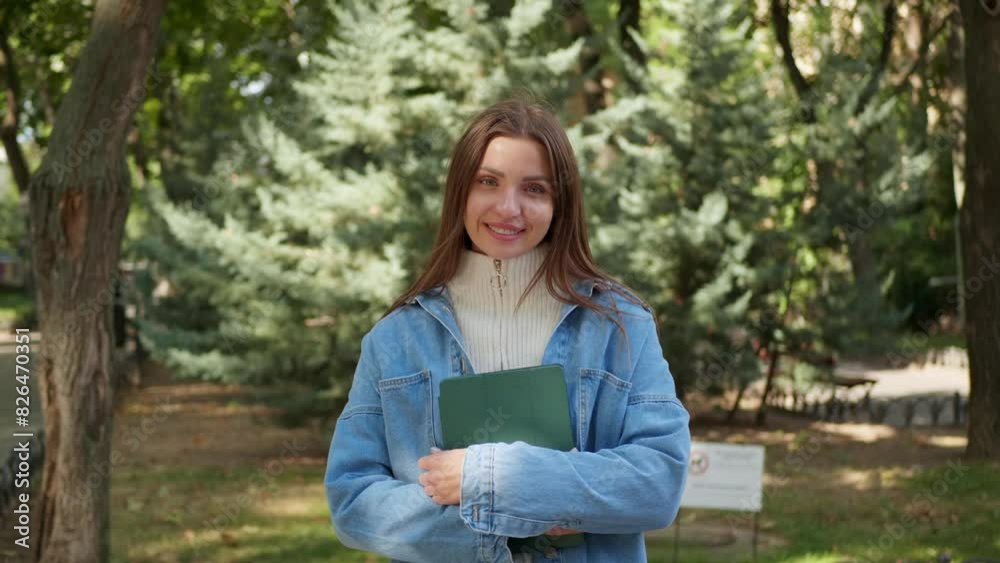 Beautiful woman with tablet in park on sunny day Beautiful woman with tablet in park on sunny day