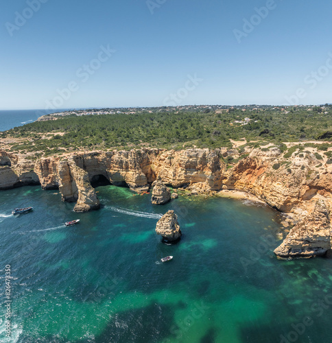 Aerial view of rugged coastal cliffs and Praia da Marinha beach, Algarve region, Portugal. photo
