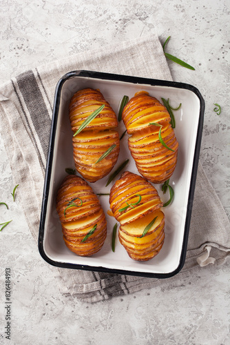 baked hasselback potato with cheddar cheese and rosemary