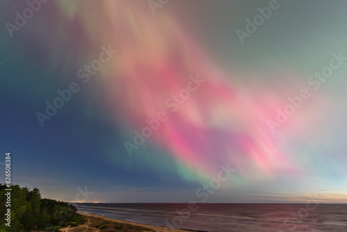 Fototapeta Naklejka Na Ścianę i Meble -  Aurora Borealis northen lights on the Baltic Sea beach in Latvia at May.