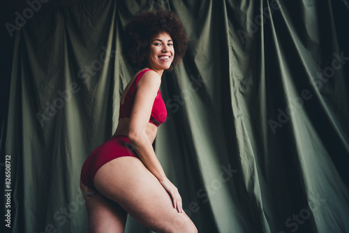 Unretouched photo of happy girl touch hips feel body positive isolated green color linen background
