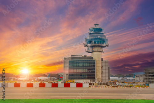 Airport control tower picturesque sky bright saturated clouds gradient background during sunset.