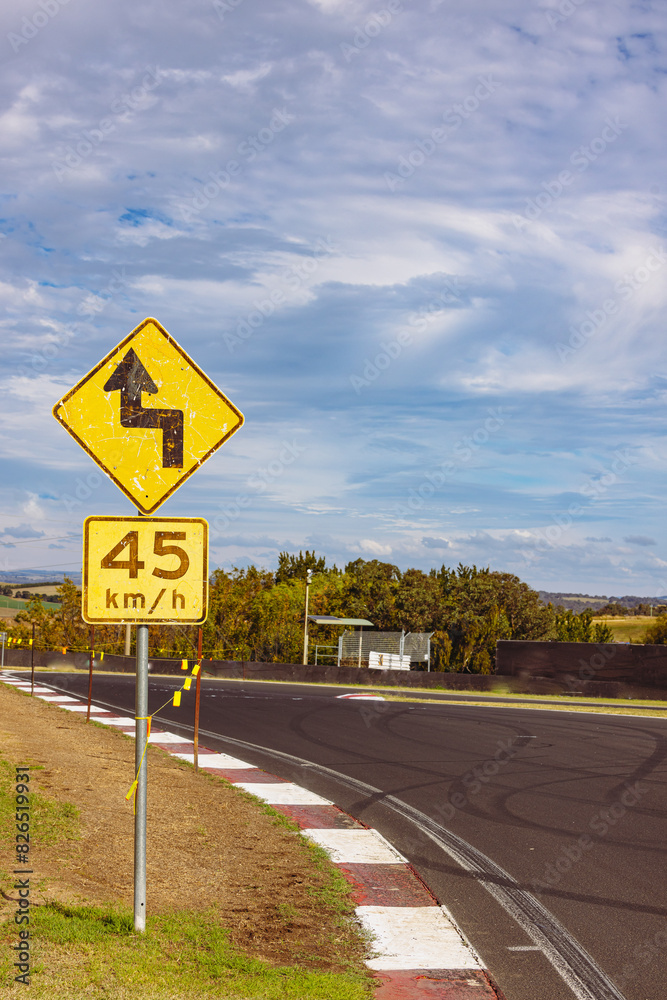 Winding road warning sign on the Mount Panorama racing circuit public road Winding road warning sign on the Mount Panorama racing circuit public road