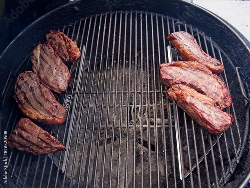 Obraz na płótnie Sirloin cap steaks, also called picanha, smoked and grilled on the old-fashioned kettle charcoal grill w salonie