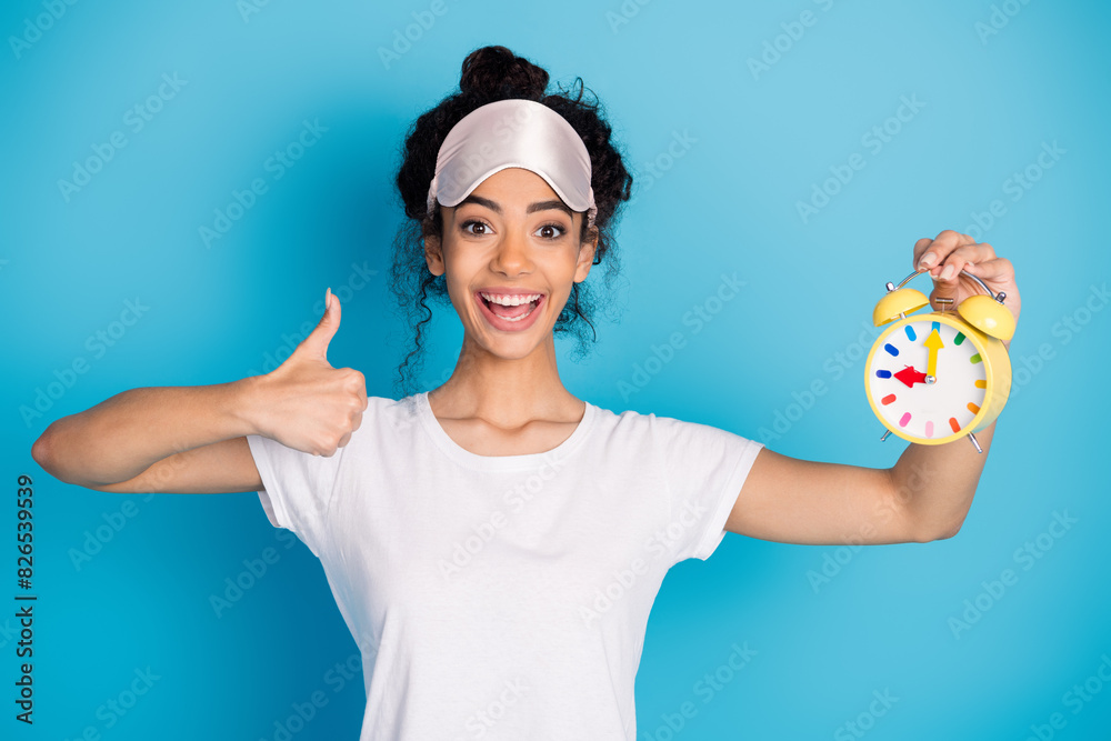 Photo of nice young woman alarm thumb up wear pajama isolated on blue color background Photo of nice young woman alarm thumb up wear pajama isolated on blue color background