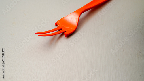 broken orange plastic fork isolated on white with empty space for advertising.