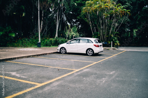 White car parked in empty car park photo
