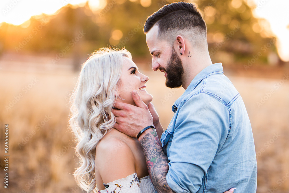 Young couple looking at each other smiling man holding woman's face Young couple looking at each other smiling man holding woman's face