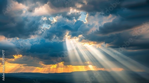Sun rays breaking through dramatic clouds over a serene landscape at sunset  casting a beautiful and heavenly glow on the scene below.