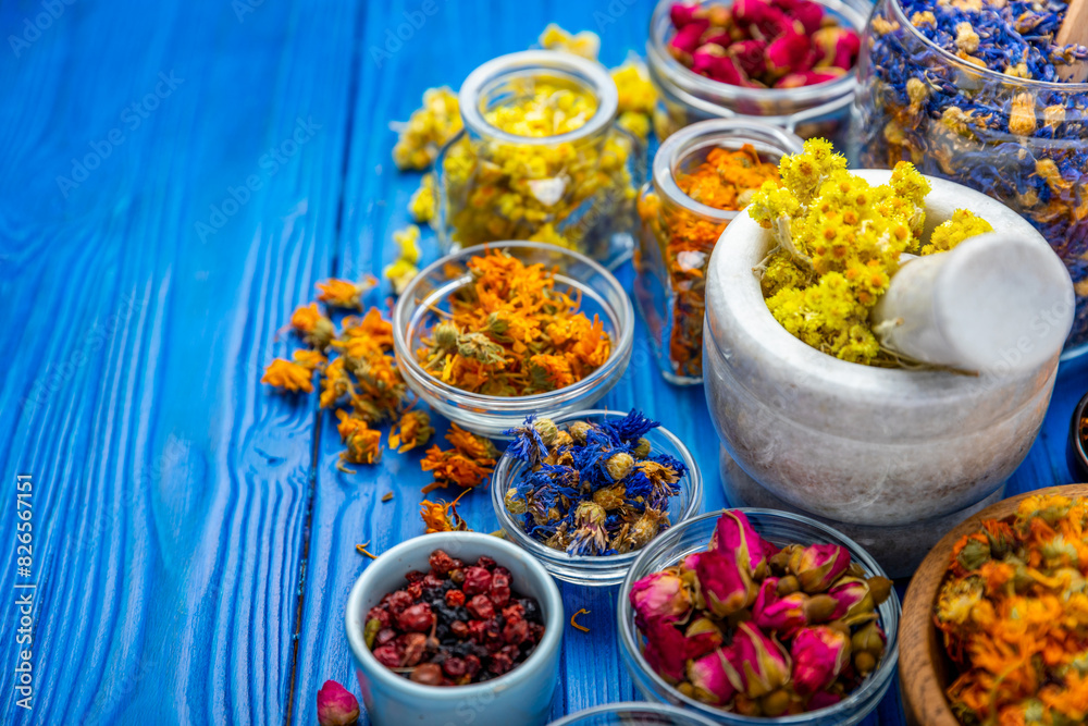 Assortment of dry herbal and berry tea on a wooden background. Tea party concept. medicinal herbs. Healing herbs.Alternative medicine.Linden, calendula, cornflowers, marigold, tansy, tea rose.