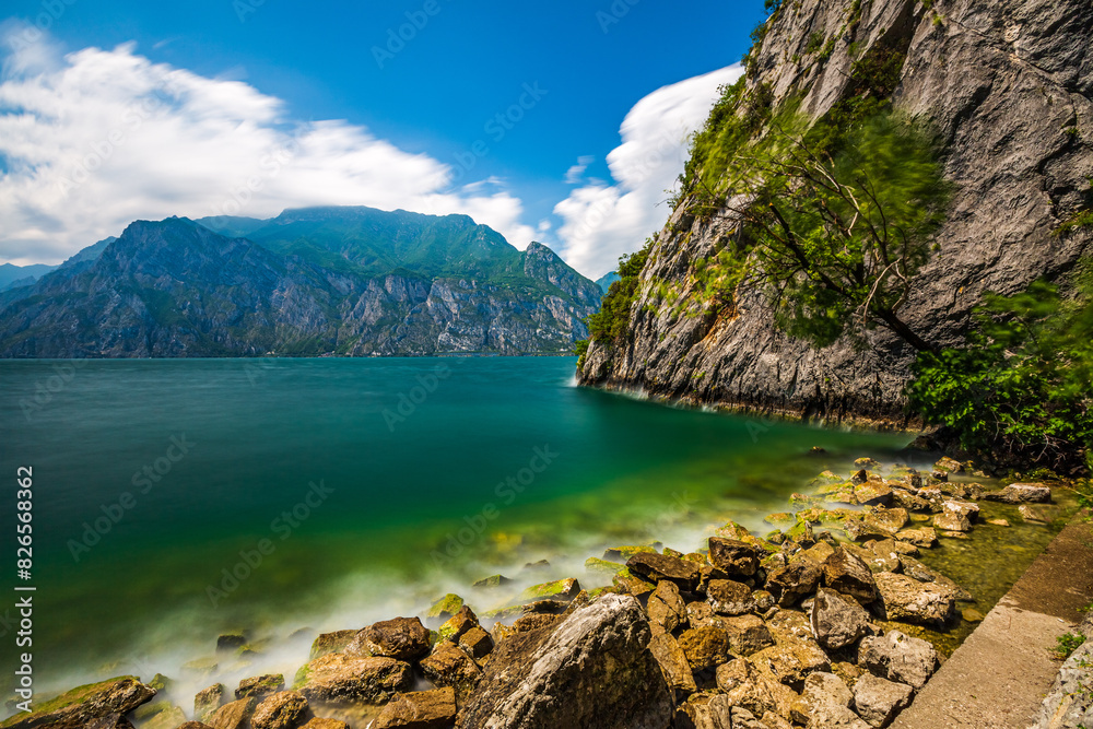 Relaxing on the Shores of Lake Garda: A Scenic View of Malcesine Beach Relaxing on the Shores of Lake Garda: A Scenic View of Malcesine Beach
