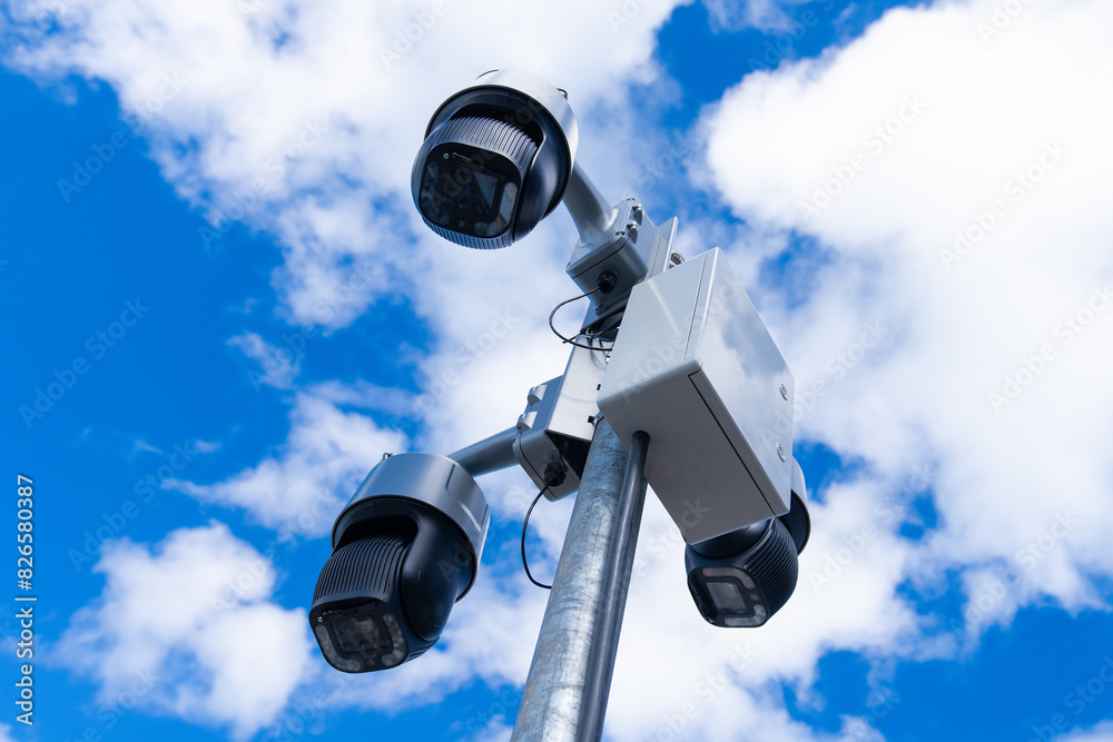 Video surveillance and monitoring of law and order on city streets. Large outdoor CCTV cameras mounted on a pole against the blue sky. Street video surveillance. Video surveillance and monitoring of law and order on city streets. Large outdoor CCTV cameras mounted on a pole against the blue sky. Street video surveillance.