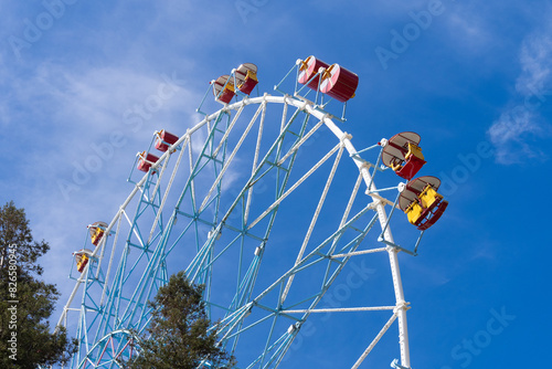 Ferris wheel against the blue sky. Modern Ferris wheel. Big, tall white Ferris wheel in front of a perfect blue sky. Happy summer vacation feelings. Sochi Ferris wheel 