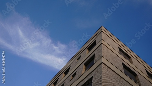 corner of the facade of a white brick residential building