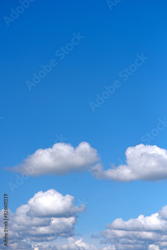 small soft cumulus fair weather clouds in a blue sky