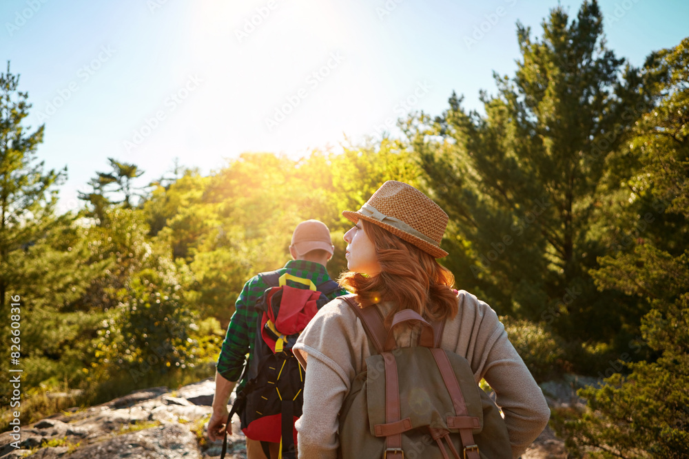 Mountain, hiking and couple with sunshine, walking and adventure holiday in nature from back. Trekking, man and woman on travel vacation together in park with trees, bush and outdoor climbing date Mountain, hiking and couple with sunshine, walking and adventure holiday in nature from back. Trekking, man and woman on travel vacation together in park with trees, bush and outdoor climbing date