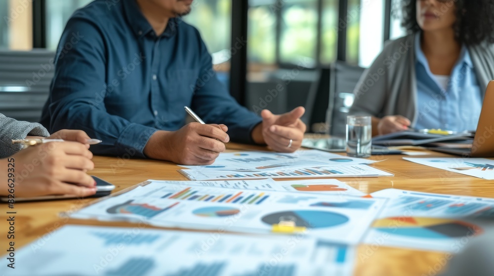 Close-up of a manager discussing quarterly goals with a diverse team in a modern office Close-up of a manager discussing quarterly goals with a diverse team in a modern office