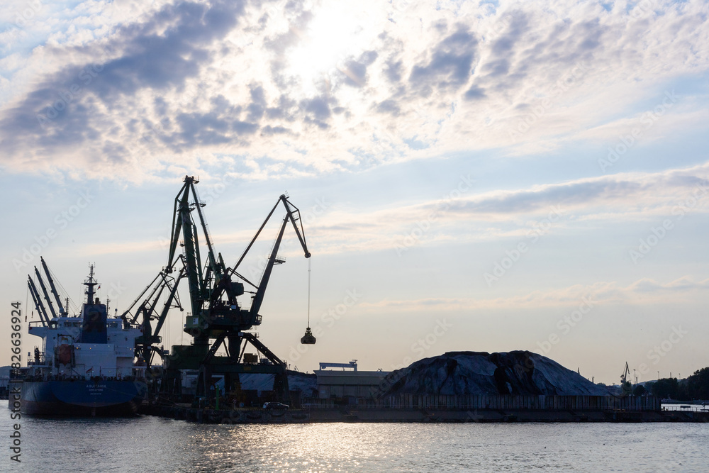 Gdynia port at sunset time,  silhouettes and sea, Poland