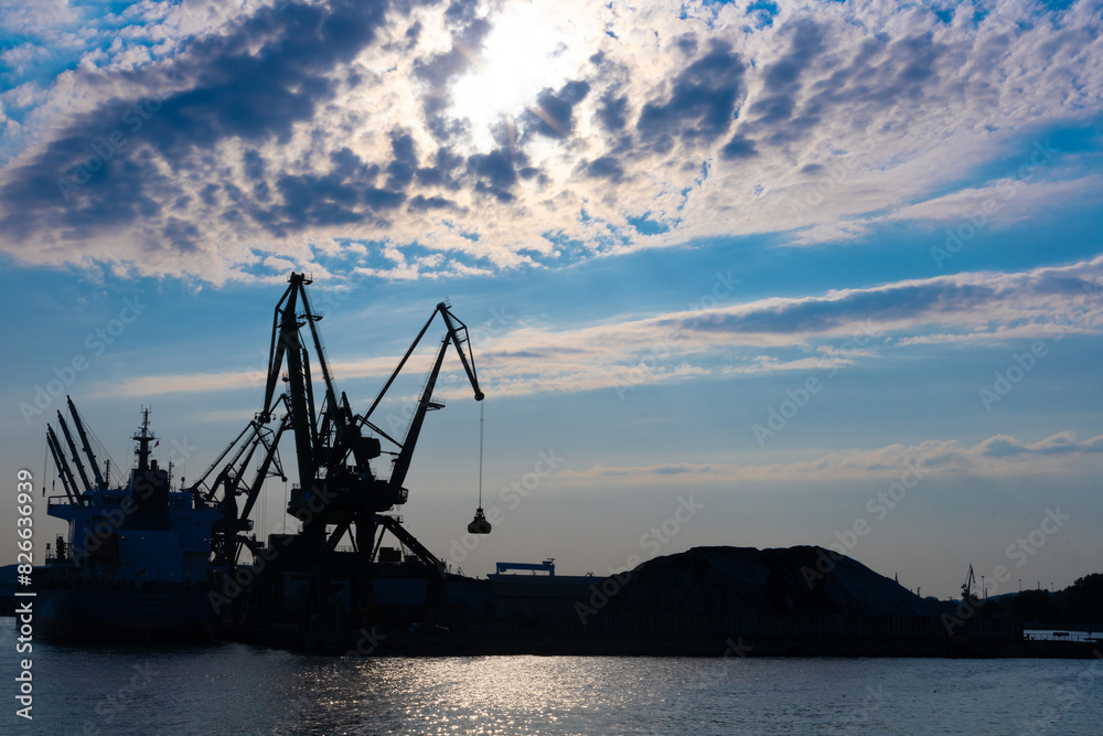 Gdynia port at sunset time,  silhouettes and sea, Poland