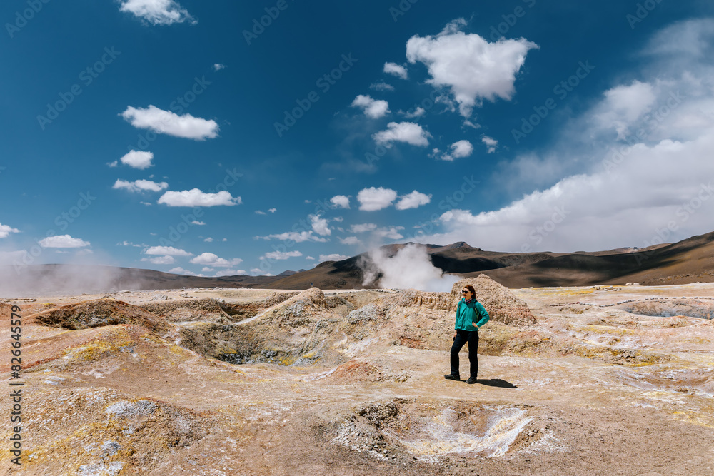 A tourist on the background of the Sol de Mañana geysers in Bolivia