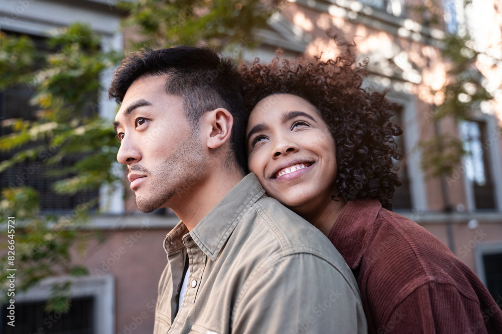 Multiethnic couple enjoying a moment together in vibrant Madrid streets Multiethnic couple enjoying a moment together in vibrant Madrid streets