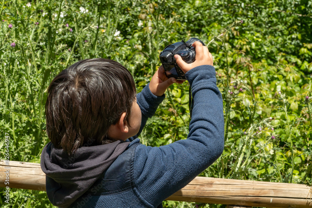 Child exploring nature with camera on a spring weekend Child exploring nature with camera on a spring weekend