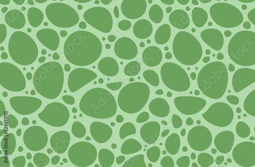 Seamless pattern of green slobs on a light green background. Organic shapes vector design for textiles, wallpapers, and prints.  photo