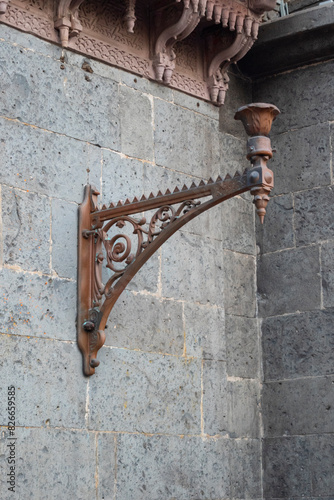 Decorative cast iron shelf bracket for ancient hanging lamp light on the wall of Rajwada, Indore, Madhya Pradesh. Indian Architecture. Ancient Architecture of Indian temple. photo
