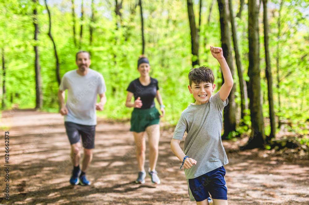 A Family exercising and jogging together at an outdoor park having great fun A Family exercising and jogging together at an outdoor park having great fun