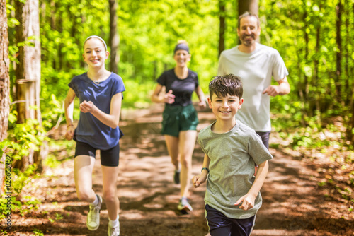 A Family exercising and jogging together at an outdoor park having great fun